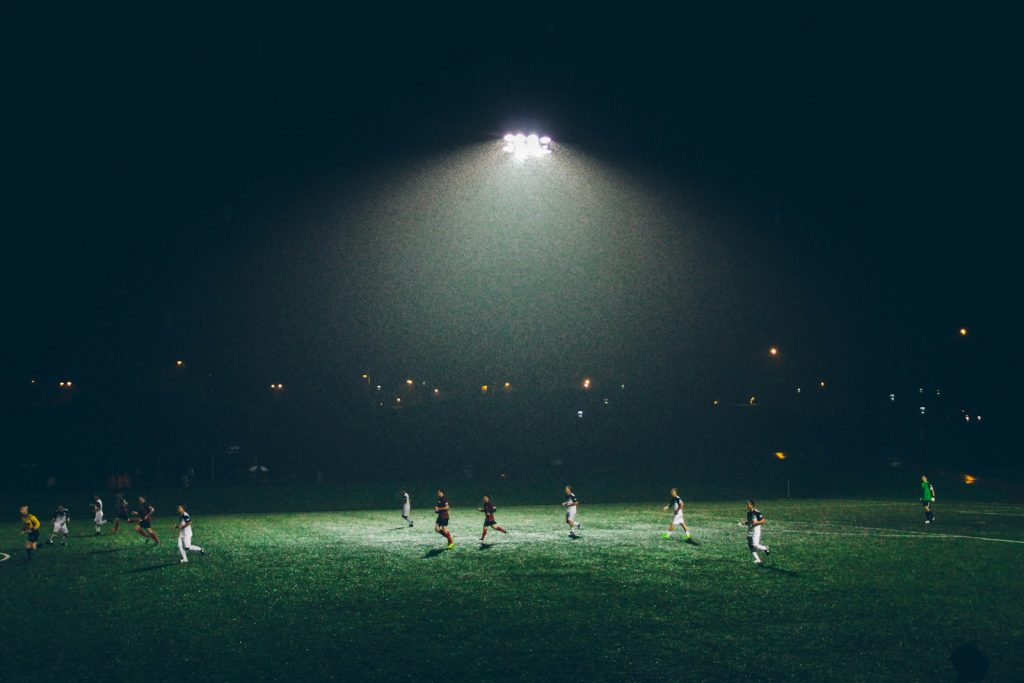 A community of men playing sport, reflecting importance of support networks helping men after miscarriage.