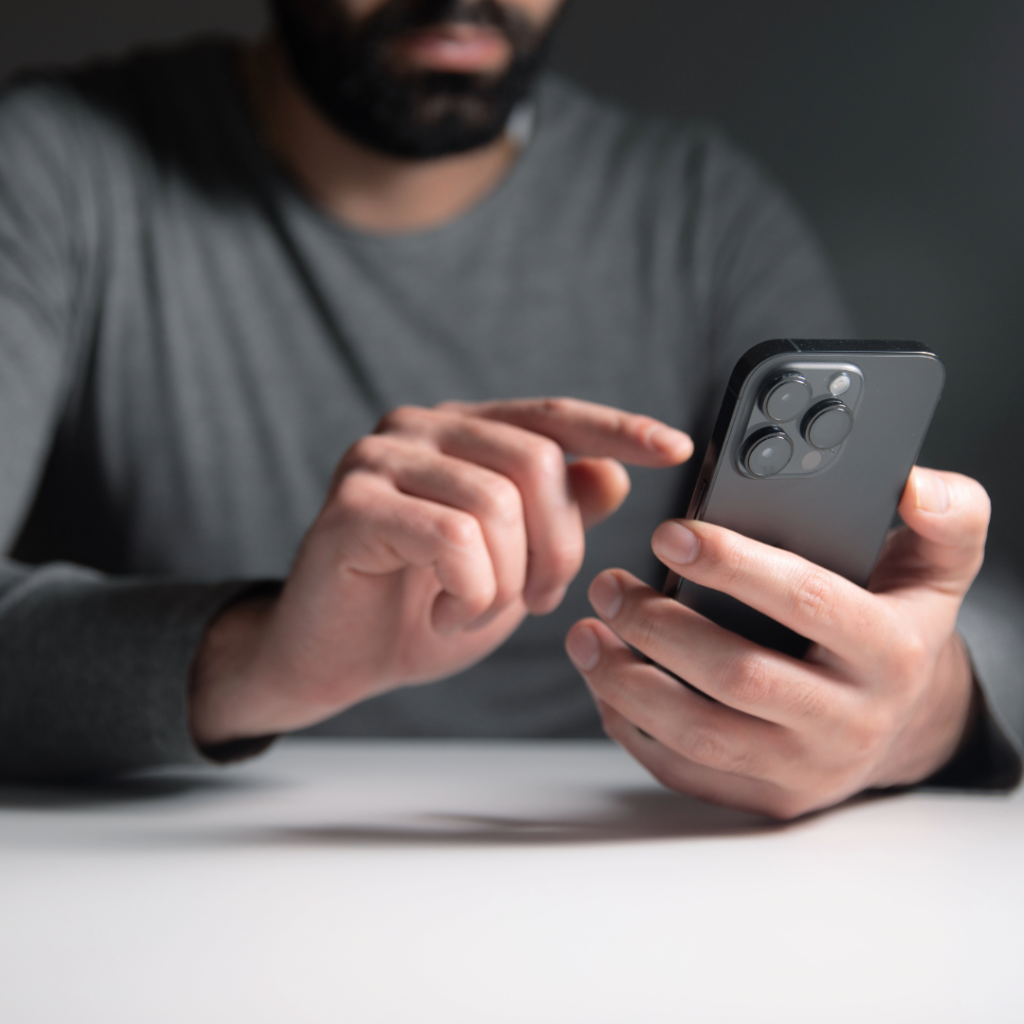 Man using a smartphone, reflecting personal impact of baby loss and looking for answers